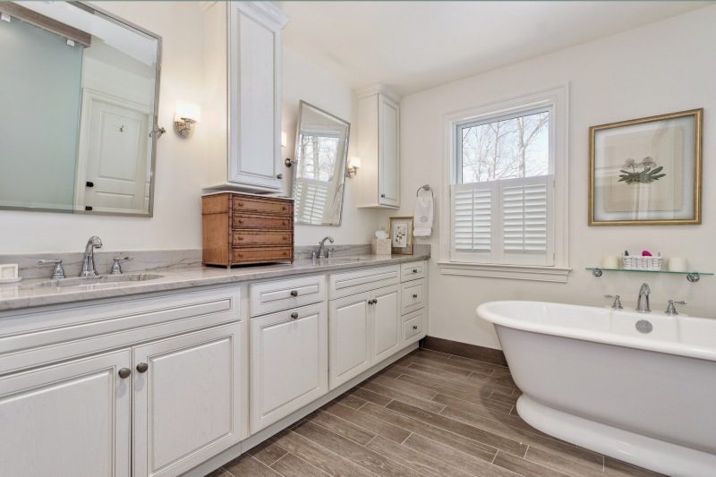 grey-countertop-sink-with-white-wood-base-custom-wood-floors-and-freestanding-bathtub
