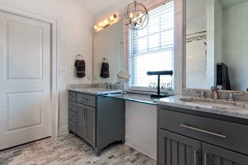 bathroom-with-custom-tile-floor-dark-grey-sink-base-overhead-light-fixtures