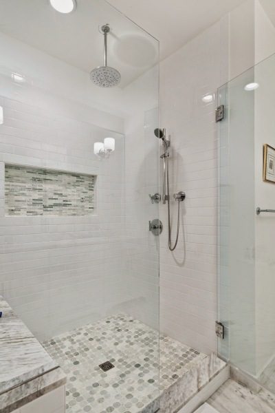 white-custom-tile-walk-in-shower-adjustable-shower-head-glass-door