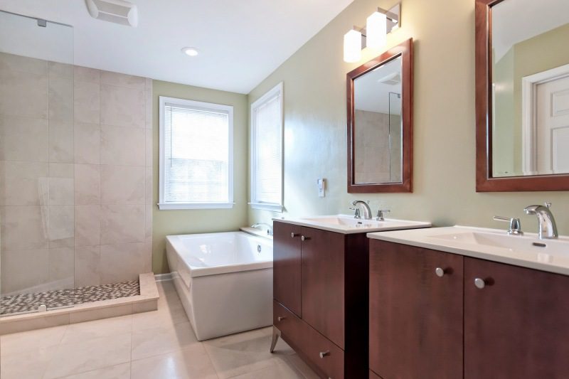 bathroom-with-custom-tile-walk-in-shower-white-sink-dark-brown-wood-base-corner-bathtub