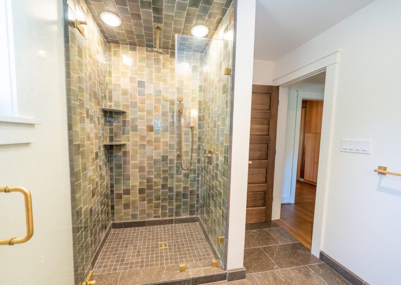 Bathroom With Custom Tile Hinged Glass Door Gold Accents