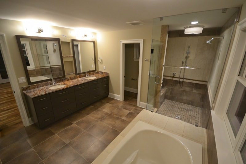 bathroom-with-dark-brown-custom-tile-walk-in-shower-stand-alone-toilet-corner-bathtub