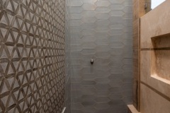 walk-in-shower-with-overhead-shower-head-and-light-grey-custom-tiles-powder-bathroom