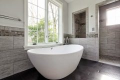 gray-stone-bathroom-with-freestanding-white-tub